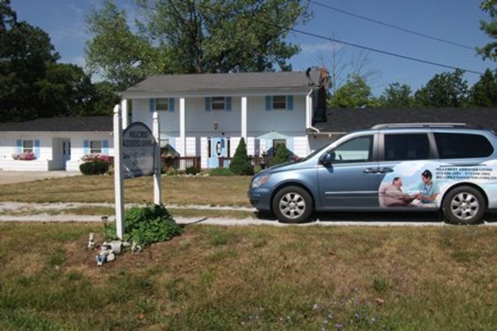Hillcrest Assisted Living building exterior with facility vehicle